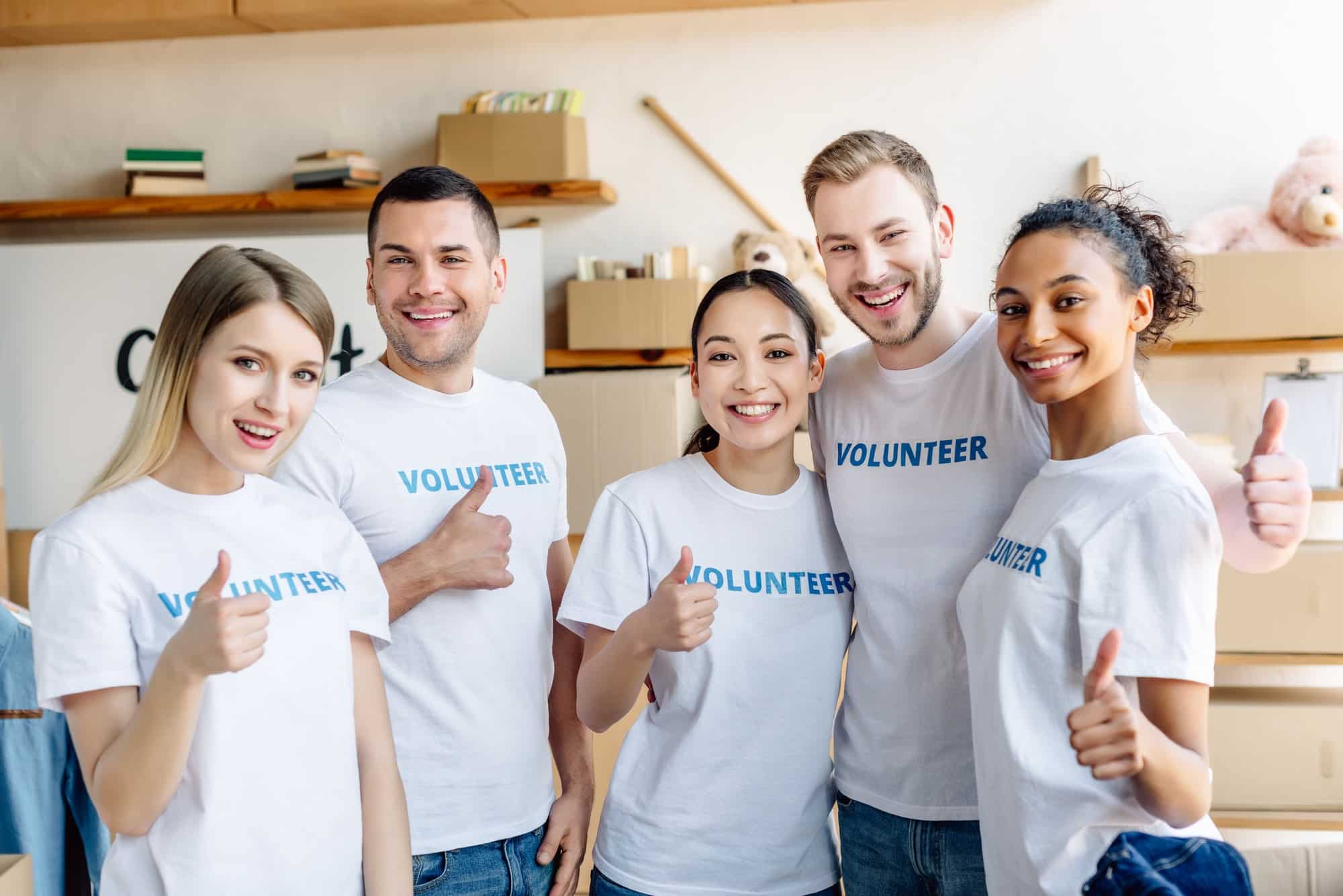 five-young-multicultural-volunteers-showing-thumbs-up-smiling-and-looking-at-camera.jpg